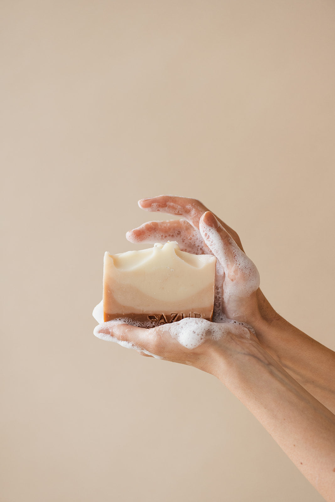 Naturseife „Sunset Dreams“ von Azur Natural Bodycare – in Hand mit Schaum präsentiert