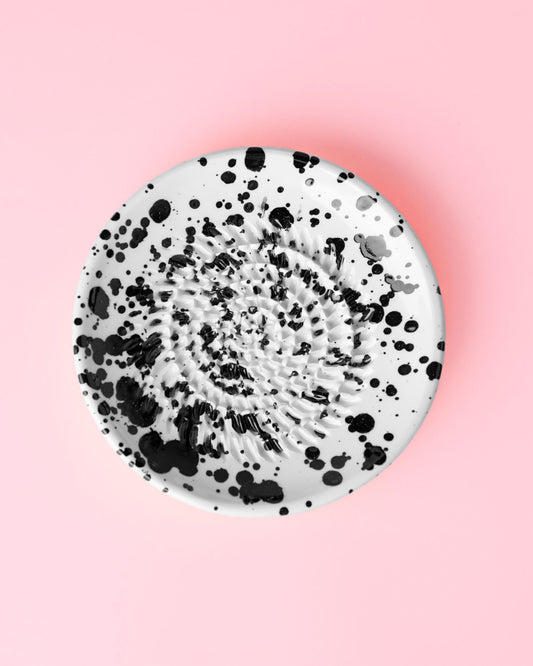 Kleine, handgefertigte Keramikreibe mit schwarzen Klecksen - ideal geeignet für Knoblauch, Ingwer oder Schokolade.